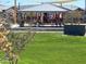 Community playground with covered pavilion and play structures at 16068 W Questa Dr, Surprise, AZ 85387