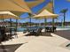 Community pool area with tables and chairs for relaxation at 16068 W Questa Dr, Surprise, AZ 85387