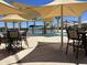 Community pool with tables and chairs under shade structures at 16068 W Questa Dr, Surprise, AZ 85387