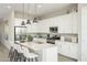 Modern kitchen with white cabinets, a large island, and stainless steel appliances at 17604 W Victory St, Goodyear, AZ 85338