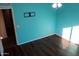 Bedroom with teal walls and wood-look flooring at 1807 S 234Th Ln, Buckeye, AZ 85326