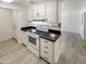 White kitchen with black countertops and electric stove top at 1836 N 66Th Dr, Phoenix, AZ 85035