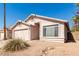 Light colored single story home with a two car garage and small front yard at 2304 E Aire Libre Ave, Phoenix, AZ 85022