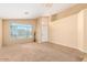 Bright living room with tile flooring and a large window at 2304 E Aire Libre Ave, Phoenix, AZ 85022