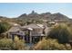 Luxury home with stone exterior, large driveway, and mountain views at 27939 N 100Th Pl, Scottsdale, AZ 85262