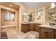 Elegant bathroom with a large soaking tub, double vanity, and granite countertops at 27939 N 100Th Pl, Scottsdale, AZ 85262