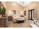 Spacious bedroom with hardwood floors and access to private balcony at 27939 N 100Th Pl, Scottsdale, AZ 85262