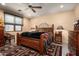 Comfortable bedroom with a wooden bed frame and a ceiling fan at 27939 N 100Th Pl, Scottsdale, AZ 85262