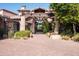 Elegant home entrance with stone details and lion statues at 27939 N 100Th Pl, Scottsdale, AZ 85262