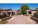 Grand home exterior with a brick driveway and landscaping at 27939 N 100Th Pl, Scottsdale, AZ 85262