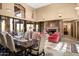 Spacious living area with fireplace, dining table, and high ceilings at 27939 N 100Th Pl, Scottsdale, AZ 85262