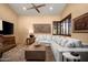 Spacious living room featuring a comfortable sectional sofa and a large flat-screen TV at 27939 N 100Th Pl, Scottsdale, AZ 85262