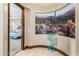 Hallway with desert landscape mural and teal metal cactus decor at 2796 E Meadowview Ct, Gilbert, AZ 85298