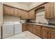 Laundry room with washer, dryer, and built-in cabinets at 2796 E Meadowview Ct, Gilbert, AZ 85298