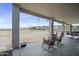 Covered patio with rocking chairs and view of the property at 28667 N Hundley Hts, San Tan Valley, AZ 85144