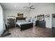 Main bedroom with dark wood furniture and a view into the bathroom at 28667 N Hundley Hts, San Tan Valley, AZ 85144