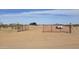 Property entrance with open red metal gate at 30314 W Wildcat Dr, Wittmann, AZ 85361