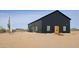 Modern black barn-style home with desert landscaping at 30314 W Wildcat Dr, Wittmann, AZ 85361