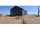 Contemporary black metal barn-style home in desert setting at 30314 W Wildcat Dr, Wittmann, AZ 85361