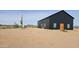 Stylish black barn-style house on a desert lot at 30314 W Wildcat Dr, Wittmann, AZ 85361
