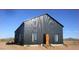 Modern black barn-style home with wooden accents at 30314 W Wildcat Dr, Wittmann, AZ 85361