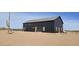 Modern barn-style home with solar panels and desert views at 30314 W Wildcat Dr, Wittmann, AZ 85361