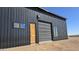 Barn-style home with metal siding and roll-up door at 30314 W Wildcat Dr, Wittmann, AZ 85361