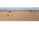 Desert lot with water and solar features at 30314 W Wildcat Dr, Wittmann, AZ 85361