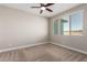 Well-lit bedroom with ceiling fan and neutral decor at 39813 N Staman St, San Tan Valley, AZ 85140