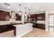 Modern kitchen with island, stainless steel appliances, and dark wood cabinets at 39813 N Staman St, San Tan Valley, AZ 85140