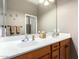 Clean bathroom with double sinks and wood cabinets at 42424 N Gavilan Peak Pkwy # 42206, Anthem, AZ 85086