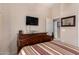 Bedroom with dresser and access to another room at 42424 N Gavilan Peak Pkwy # 42206, Anthem, AZ 85086