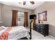 Well-lit bedroom featuring a dresser and wall-mounted TV at 42424 N Gavilan Peak Pkwy # 42206, Anthem, AZ 85086