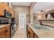 Kitchen with double sink and wood cabinets at 42424 N Gavilan Peak Pkwy # 42206, Anthem, AZ 85086