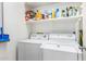 Laundry room with washer, dryer, and storage shelves at 42424 N Gavilan Peak Pkwy # 42206, Anthem, AZ 85086
