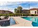 Community pool area with a water feature and seating at 42424 N Gavilan Peak Pkwy # 42206, Anthem, AZ 85086