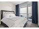 Bright bedroom with a comfortable queen-size bed and access to a private balcony at 4739 N Scottsdale Rd # 2002, Scottsdale, AZ 85251