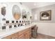 Elegant bathroom with dual vanities, decorative mirrors and patterned wallpaper at 5733 N 10Th Pl, Phoenix, AZ 85014