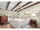 Spacious main bedroom with exposed wooden beams and a ceiling fan at 5733 N 10Th Pl, Phoenix, AZ 85014