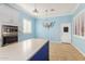 Bright kitchen with light blue walls, an island, and a charming chandelier at 660 E Riviera Dr, Chandler, AZ 85249