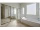 Bathroom features a soaking tub, shower, and tiled floor at 9443 W Melinda Ln, Peoria, AZ 85382