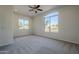 Well-lit bedroom with large window and carpet flooring at 9443 W Melinda Ln, Peoria, AZ 85382