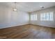 Bright dining room with wood-look flooring and a chandelier at 9443 W Melinda Ln, Peoria, AZ 85382