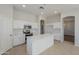 Modern kitchen with white cabinets, quartz countertops, and an island at 9443 W Melinda Ln, Peoria, AZ 85382