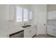 Modern kitchen with white shaker cabinets and a double sink at 9443 W Melinda Ln, Peoria, AZ 85382