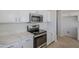 Modern kitchen with stainless steel appliances and white cabinets at 9443 W Melinda Ln, Peoria, AZ 85382