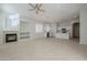 Open living space with a fireplace, kitchen view, and tile floors at 9443 W Melinda Ln, Peoria, AZ 85382