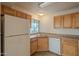 Kitchen with light wood cabinets and white appliances at 10115 E Mountain View Rd # 1119, Scottsdale, AZ 85258