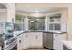 Kitchen corner sink with white cabinets and updated countertops at 1023 W Meseto Ave, Mesa, AZ 85210