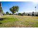 Large backyard with grassy area and mature trees at 10819 W Hatcher Rd, Sun City, AZ 85351